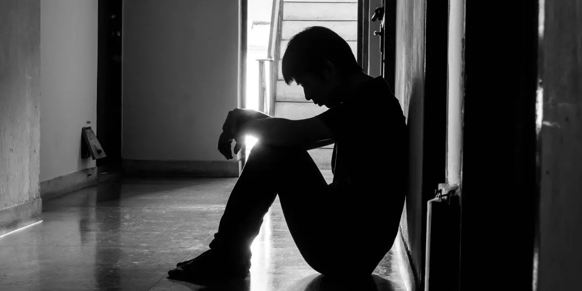 Image-3---Isolated-individual-sitting-in-solitude-in-dimly-lit-hallway.jpg