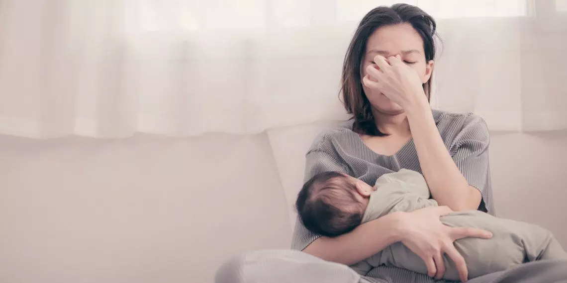 Image3-tired-mom-holding-baby-postpartum-stress.jpg