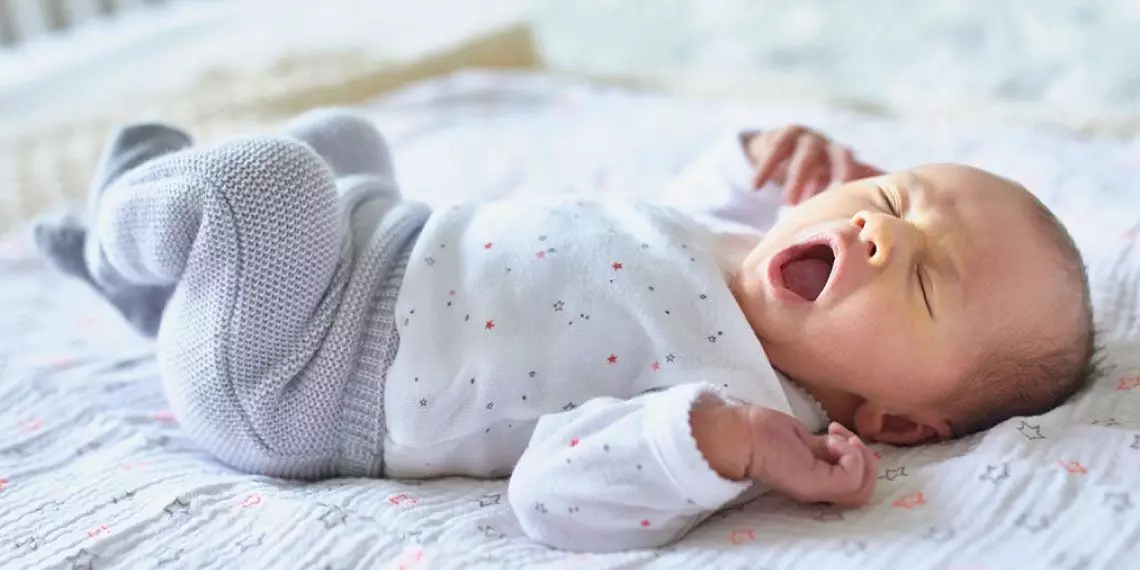 Baby in winter pajamas getting ready to nap