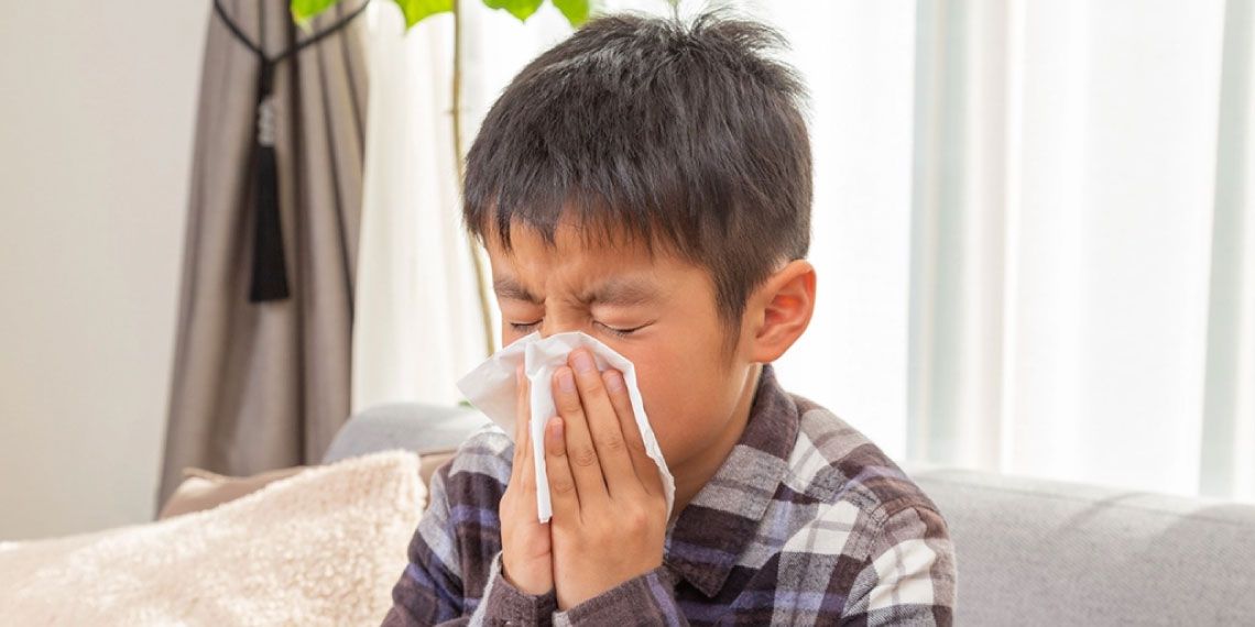 Child Blowing Nose Due to Winter Dryness