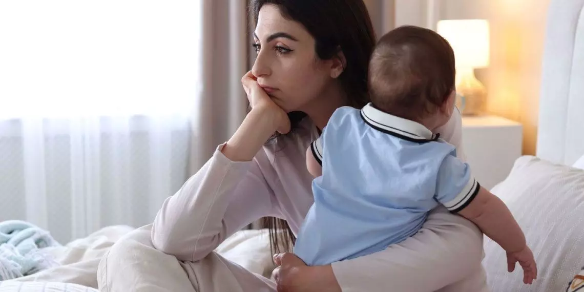 Tired mom holding her baby