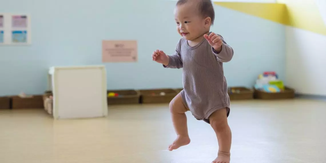 Baby reaching the milestone of taking first steps