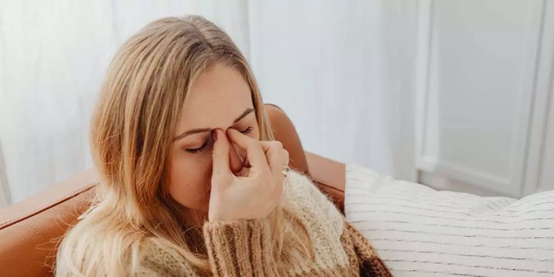 Woman-pressing-sinuses-experiencing-facial-pressure-from-cold-or-allergies.jpg