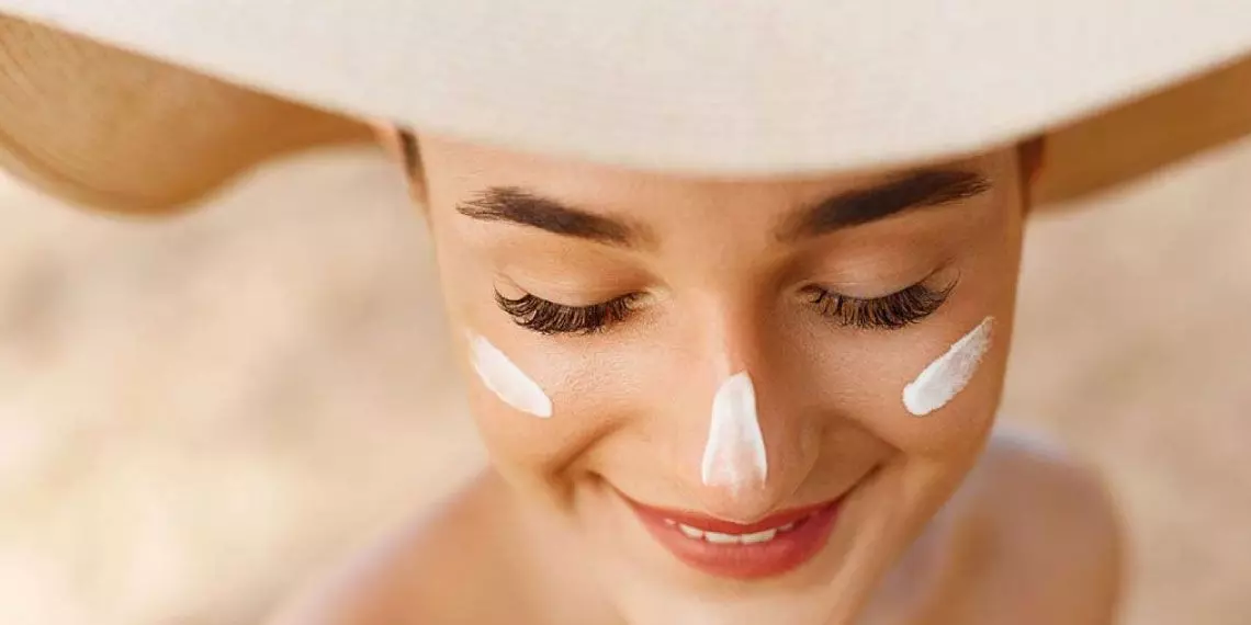 Woman-with-wide-brimmed-hat-and-sunscreen-on-face-showing-daily-skin-cancer-prevention-habits.jpg