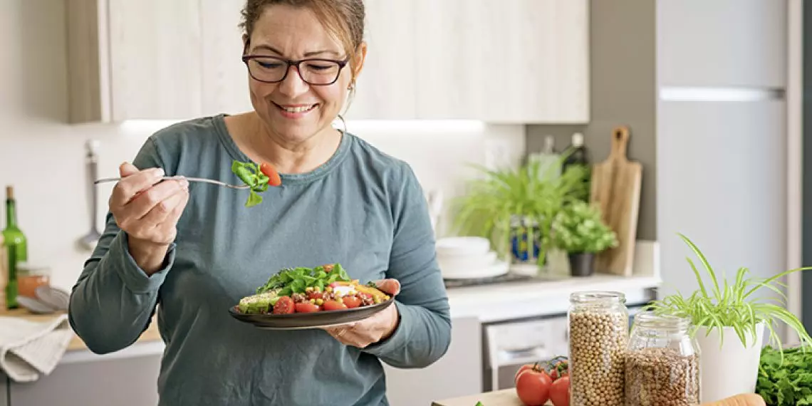 Woman eating a healthy whole-food meal while on a GLP-1 medication