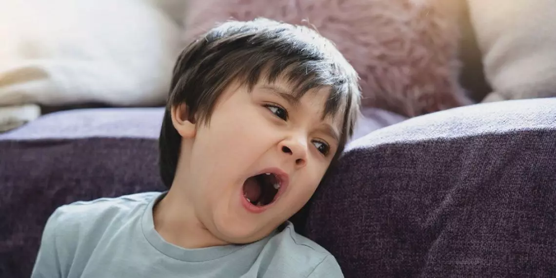 Tired child showing signs of post-holiday sleep fatigue