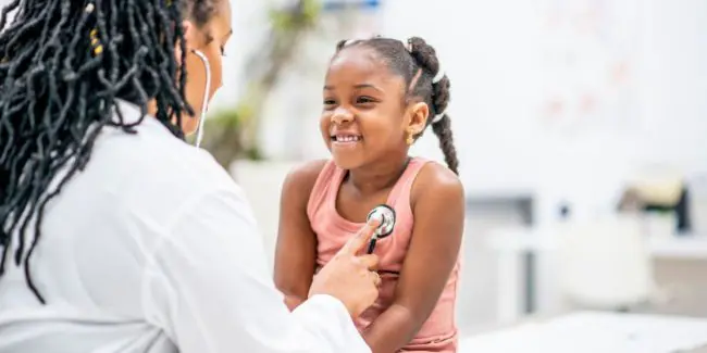 Checking vital signs during a back-to-school well child visit